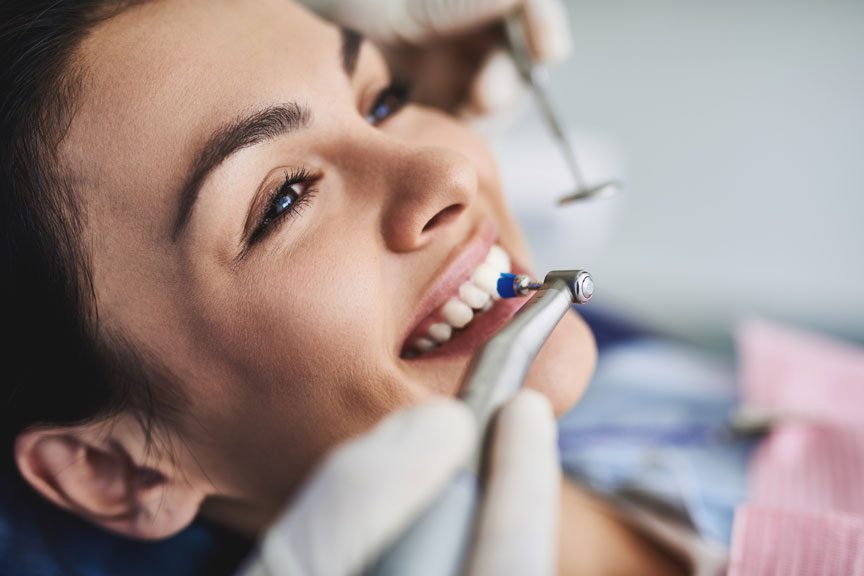 Dentist Performing Teeth Cleaning in Oakville, ON