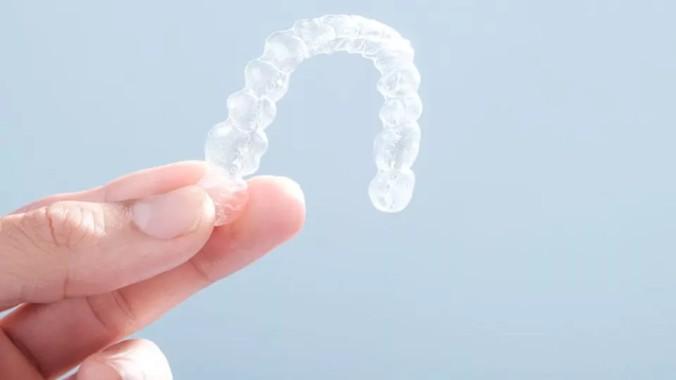 Person With An Invisalign In Hand