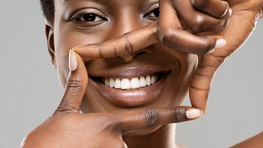 Woman Making A Frame With Her Fingers To Showcase Her Teeth