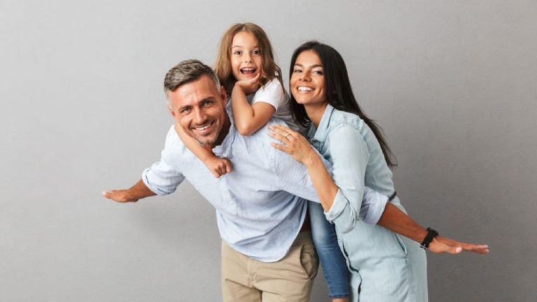 Happy Family Posing Together And Smiling